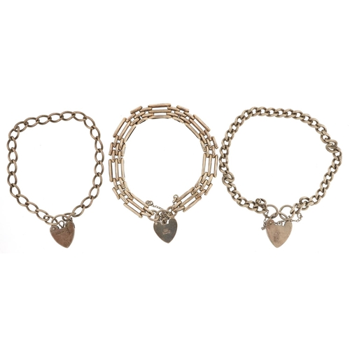 392 - Three silver bracelets with love heart padlock clasps, total 34.5g.