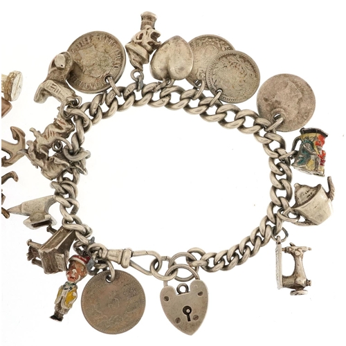 328 - Two silver and white metal charm bracelets with a collection of mostly silver charms including coins... 