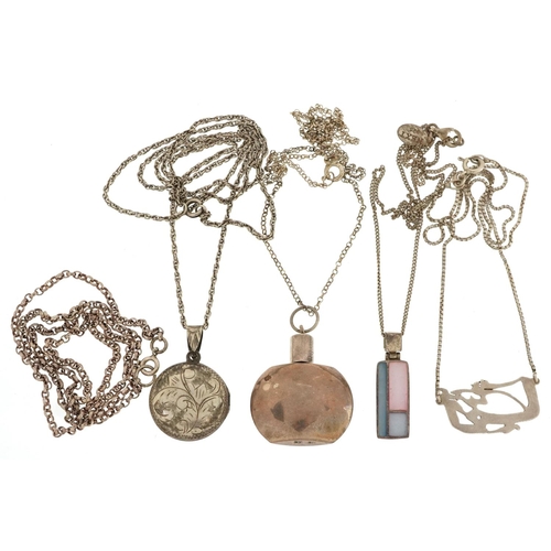 580 - Five silver necklaces, four with pendants, including miniature scent bottle and a locket, total 32.0... 