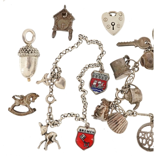 598 - A silver charm bracelet and a large collection of mostly silver charms including Gypsy carriage with... 