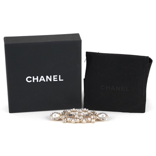 Chanel, vintage Chanel monogram brooch set with clear stones and simulated pearls, marked 19A, 7cm wide, with box.