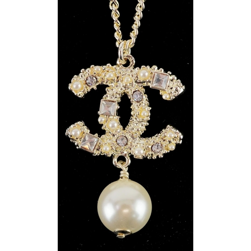  Chanel, vintage ladies Chanel monogram pendant set with clear stones and a simulated pearl, 4cm high... 