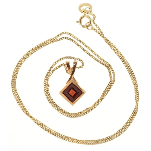 131 - A 9ct gold garnet pendant on a 9ct gold necklace, 1.5cm high and 40cm in length, total 1.8g.