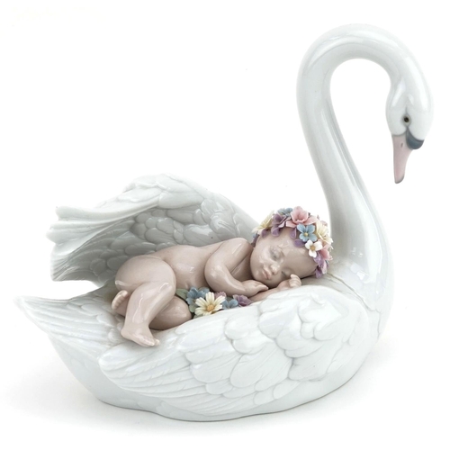 775 - A Lladro porcelain study of a baby sleeping on a swan, numbered 6758, 19cm in length.