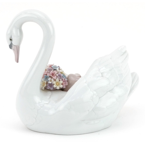 775 - A Lladro porcelain study of a baby sleeping on a swan, numbered 6758, 19cm in length.