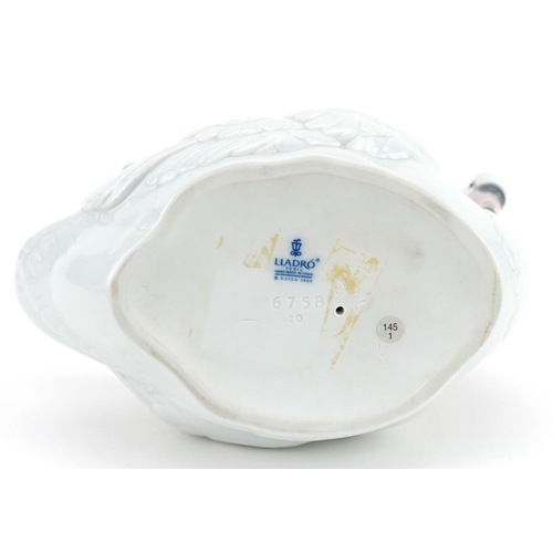 775 - A Lladro porcelain study of a baby sleeping on a swan, numbered 6758, 19cm in length.