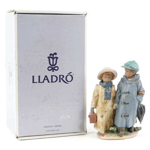 722 - A Lladro Gres figure group of a young boy and girl - Away to School, numbered 2242, 26cm high, with ... 