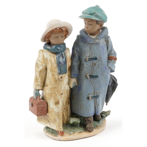 722 - A Lladro Gres figure group of a young boy and girl - Away to School, numbered 2242, 26cm high, with ... 