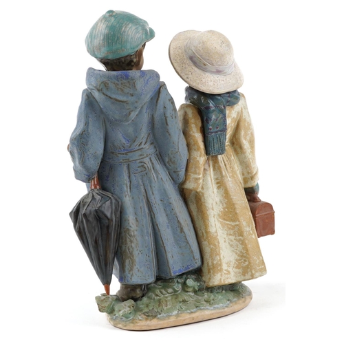 722 - A Lladro Gres figure group of a young boy and girl - Away to School, numbered 2242, 26cm high, with ... 