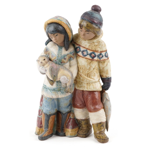 721 - A Lladro Gres figure group of an Eskimo boy and girl with seal pup and fish, numbered 2227, 30cm hig... 