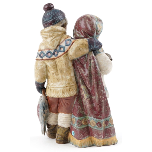 721 - A Lladro Gres figure group of an Eskimo boy and girl with seal pup and fish, numbered 2227, 30cm hig... 