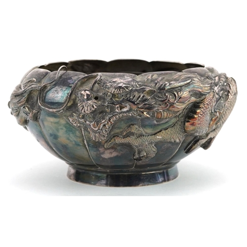  A Chinese export silver bowl embossed with a continuous dragon, with pewter liner, impressed marks t... 