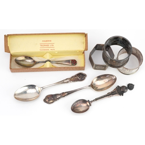 679 - Edwardian and later silver items comprising three napkin rings and four bowling club teaspoons, tota... 