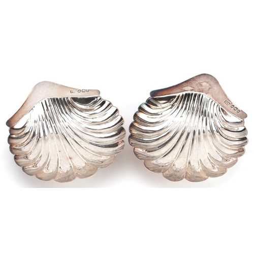  Atkin Brothers, a pair of Victorian silver shell shaped dishes, each raised on three ball feet, Shef... 