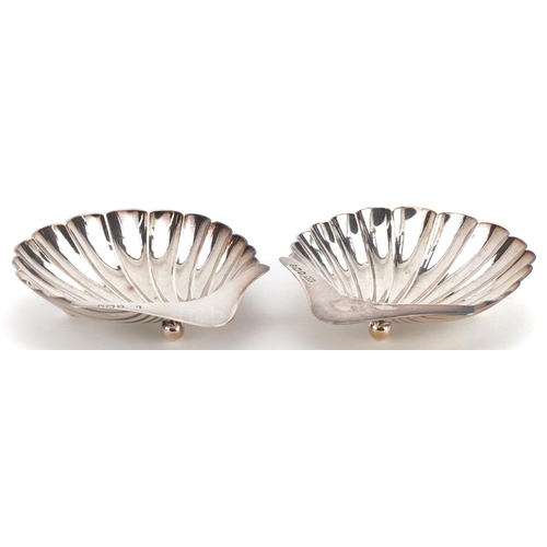  Atkin Brothers, a pair of Victorian silver shell shaped dishes, each raised on three ball feet, Shef... 