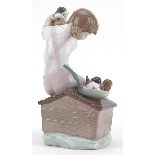 742 - A Lladro figure of girl holding a puppy - Pick of the Litter, numbered 7621, 19cm high, with box.