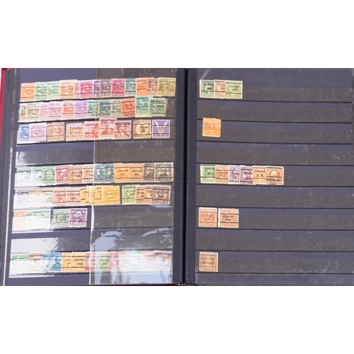 1525 - A large quantity of USA pre-cancels, some on stock cards, two stock albums and some loose stamps tog... 