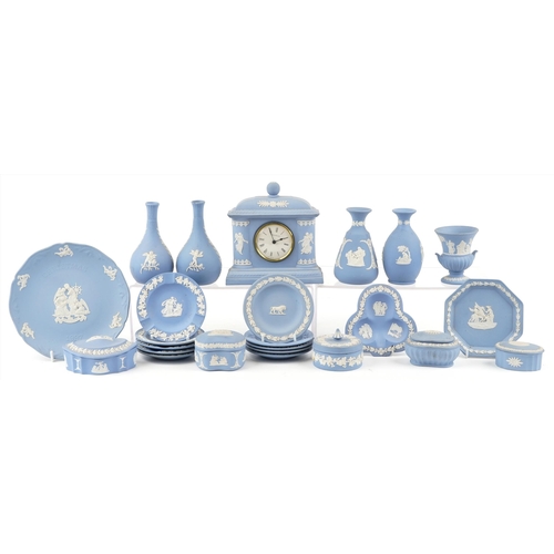 424 - A small collection of blue Wedgwood Jasperware to include trinket boxes, a mantle clock and vases.