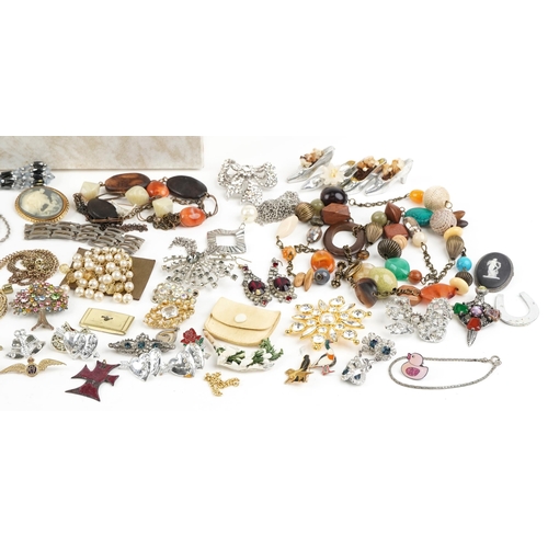 2577 - A small mixed group of costume jewellery including brooches, necklaces and pendants within a cream l... 