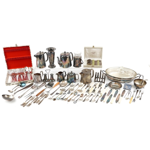 1380 - A collection of plated items to include a three piece tea set, spill vase, toast rack and various cu... 