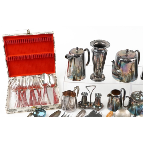 1380 - A collection of plated items to include a three piece tea set, spill vase, toast rack and various cu... 