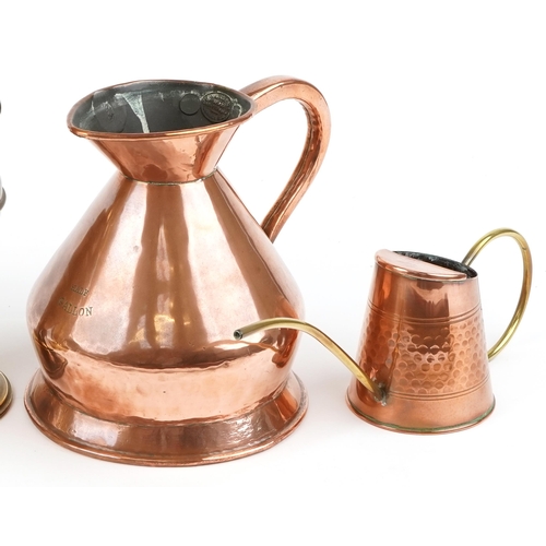 1243 - A small group of brass and copper items including a copper warming pan, an oil lamp, two jugs and a ... 