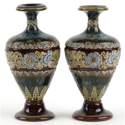 186 - A pair of Doulton Lambeth stoneware pottery vases decorated with flowers, bearing impressed marks to... 