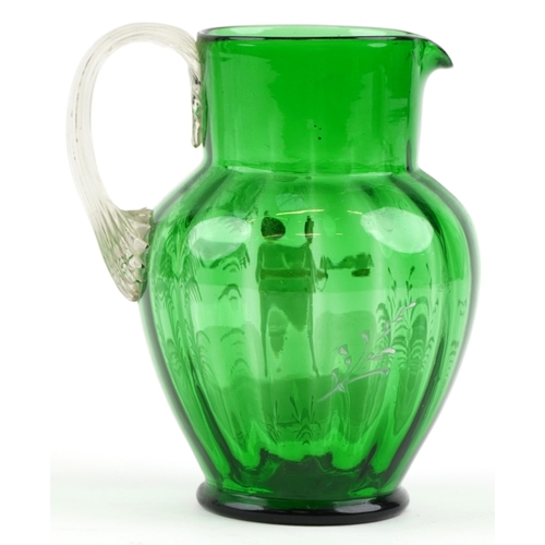 67 - A Victorian Mary Gregory green glass jug with enamelled decoration, 19cm high.