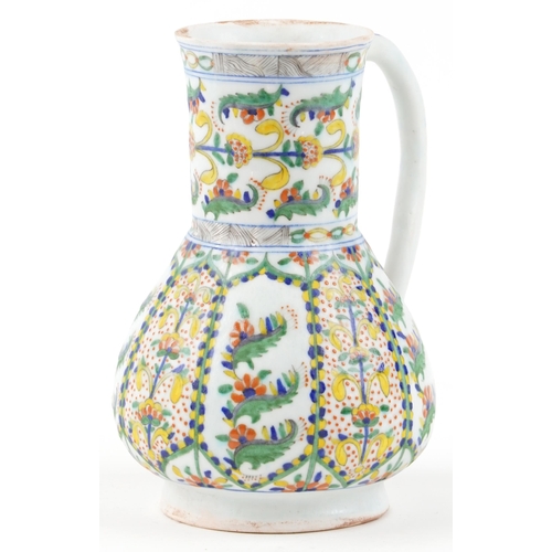 170 - A 19th century Turkish Ottoman Kütahya jug decorated with stylized flowers and motifs, 23cm high.