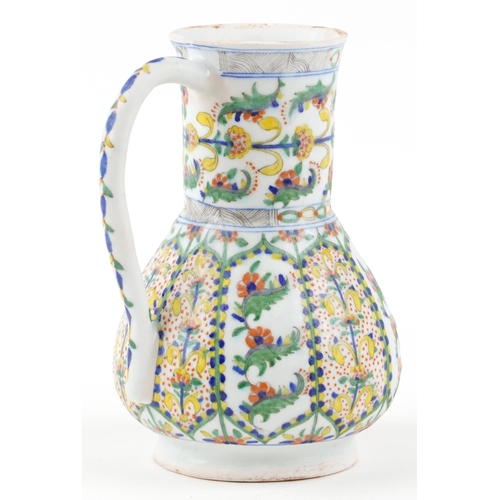 170 - A 19th century Turkish Ottoman Kütahya jug decorated with stylized flowers and motifs, 23cm high.