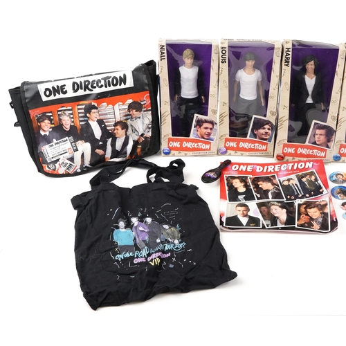 545 - A group of One Direction collectables including five figures with box, side bag, calendar and a lunc... 