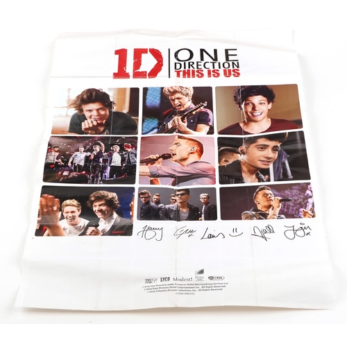 545 - A group of One Direction collectables including five figures with box, side bag, calendar and a lunc... 