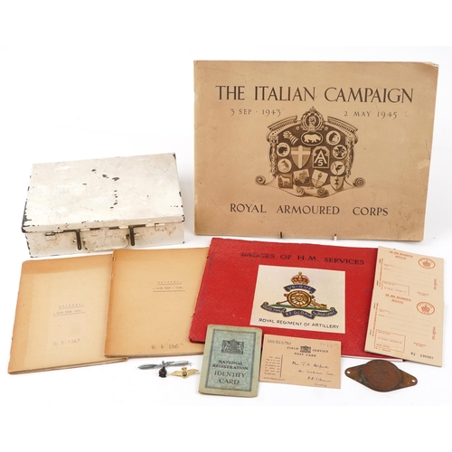 725 - A small group of militaria to include a white painted tin first aid box, a Badges of HM Services boo... 