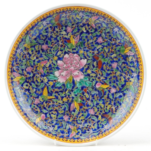 324 - A Chinese porcelain charger profusely hand painted with insects amongst flowers and foliage, charact... 