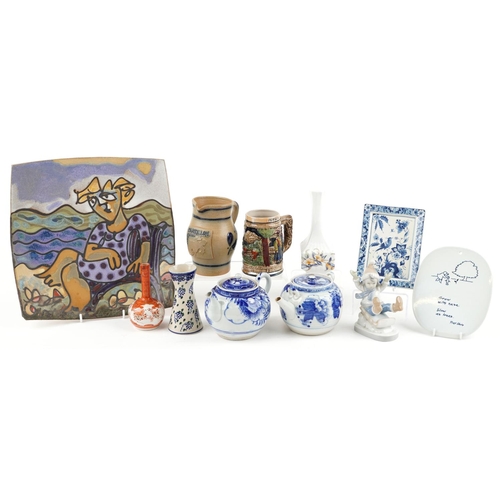 1295 - A mixed group of decorative ceramics to include a hanging wall plaque, two blue and white teapots, t... 