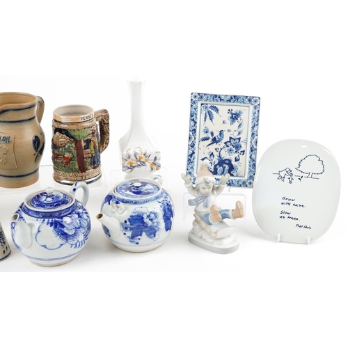 1295 - A mixed group of decorative ceramics to include a hanging wall plaque, two blue and white teapots, t... 