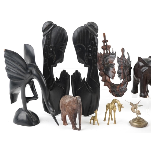 1358 - A mixed group of 20th century African items including three carved wood elephants, a carved horn mod... 