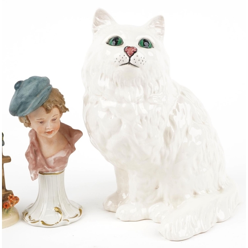 430 - A Royal Doulton pottery cat, 21cm high, together with two Goebel figures and a Capodimonte figure.