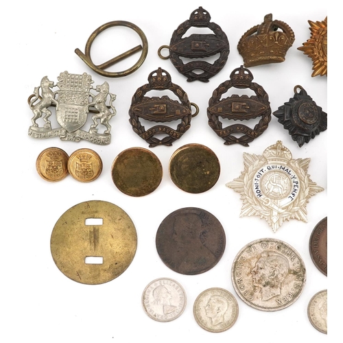 705 - A small collection of military buttons and badges.