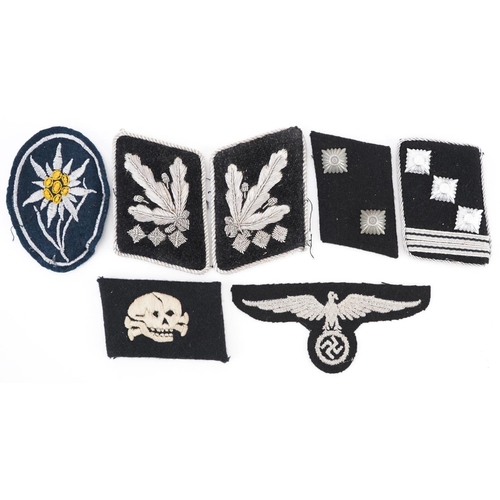 772 - Seven German military World War II tabs and cloth badges.