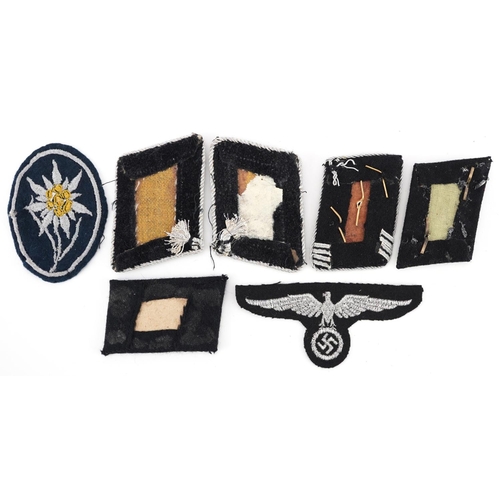 772 - Seven German military World War II tabs and cloth badges.