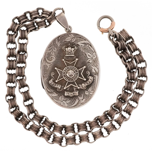 760 - A military interest King's Rifles Peninsula white metal locket on a white metal necklace, the locket... 