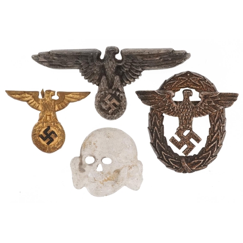 773 - Four German military interest cap badges.