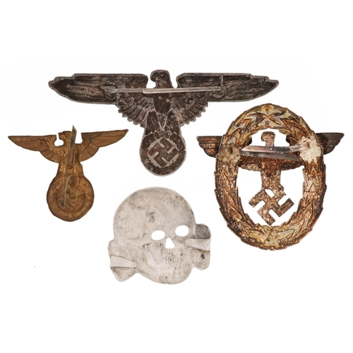 773 - Four German military interest cap badges.