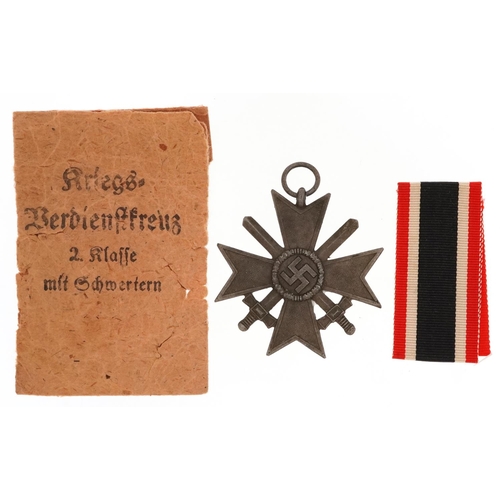 759 - A German military World War II Merit Cross with paper packet.