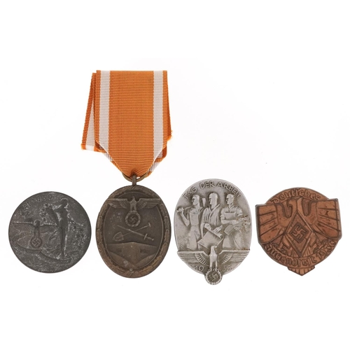 770 - Four German military interest medals and badges including Donation badge and West Wall medal.