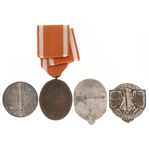 770 - Four German military interest medals and badges including Donation badge and West Wall medal.