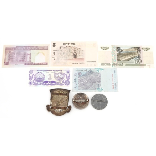 753 - Two German military interest badges, Russian military interest cap badge and world banknotes.