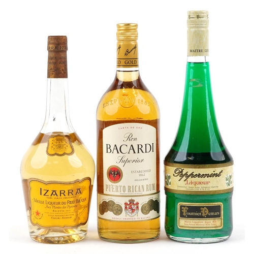 394 - Three bottles of alcohol including Bacardi Superior rum and Izarra liqueur.