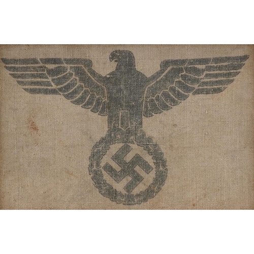 750 - A German military interest section of a military grain sack with eagle and Swastika, framed, overall... 